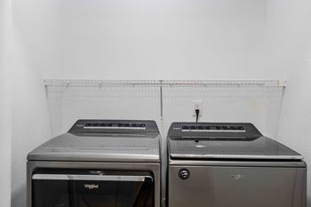 two washing machines against a wall with a rainbow on it